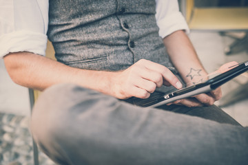 handsome big moustache hipster man using tablet