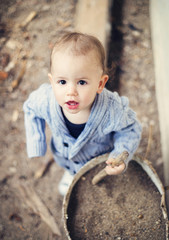 Little boy playing outside the house