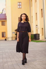 Fototapeta premium Stylish woman walking on the city street