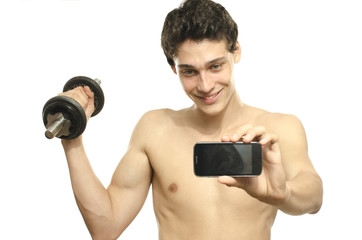 Skinny man taking selfie with phone while training biceps
