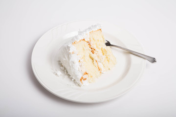Slice of Coconut Cake on White Counter
