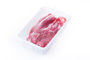raw pork in plastic box package isolated on white background