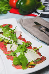 Appetizers - Meat Carpaccio with rucola leaves , parmesan cheese