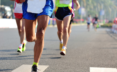 Fototapeta premium marathon athletes legs running on city road