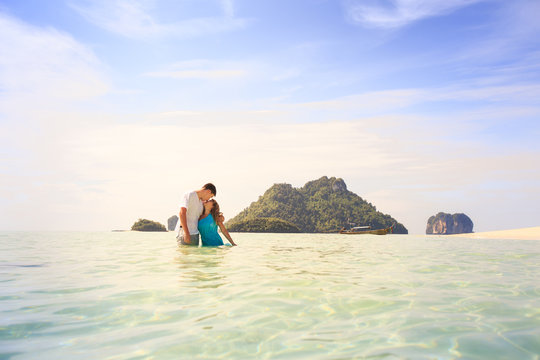 young happy asian couple on island