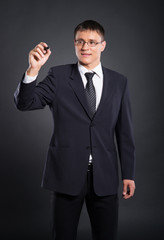 A smart businessman writing with a marker on the screen