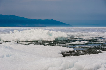 Day at Baikal Lake. Spring floating of ice