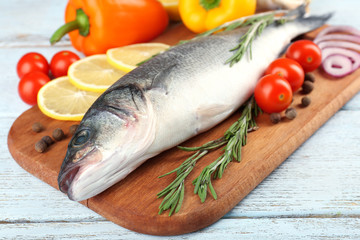 Fresh raw fish and food ingredients on table
