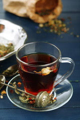 Beautiful vintage composition with herbal tea, on wooden table