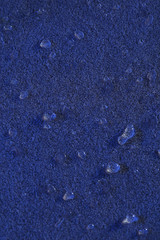 Water drops on color surface background, macro view