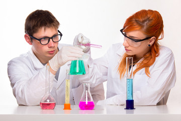 Two students in chemistry lab doing reactions