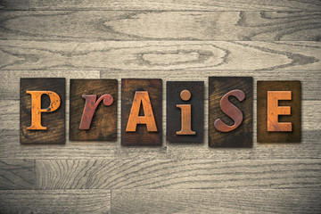 Naklejka premium Praise Concept Wooden Letterpress Type