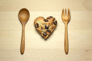 Heart chocolate chip cookie on wood table