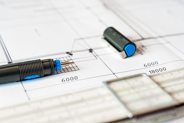 Drawing house plan, slide rule and pencil on the table