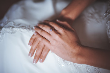 hands of bride crossed on legs