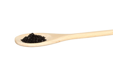 Black salt on a light colored wooden spoon