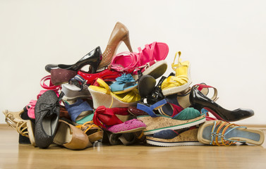 Big pile of colorful woman shoes.