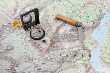 Compass and wooden-handled knife on a hiking map