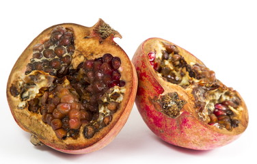 Rotten pomegranate on a white background