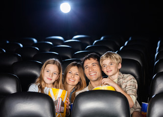Happy Family Watching Film In Theater