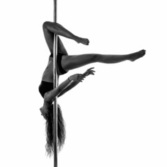 Silouette of woman performing pole dance. Studio shot, black and
