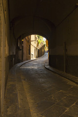 Fototapeta premium Narrow street in an old town from Tuscany
