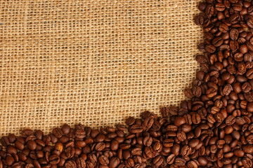 Coffee beans on brown sack background