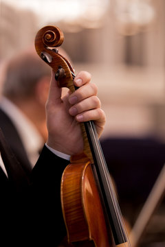 Hand holding a violin musician