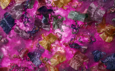 Fototapeta na wymiar colored shiny thread on lilac background