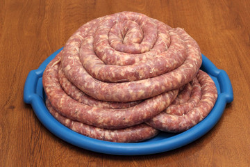 Home-made sausage on the blue tray