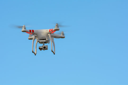 Flying drone with clear blue sky