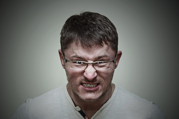 Obraz premium Aggressive brutal man with glasses. Emotional expression