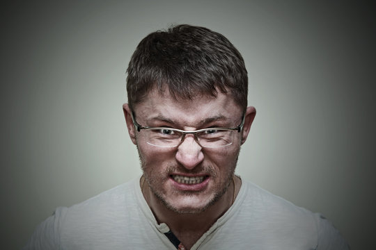 Aggressive brutal man with glasses. Emotional expression