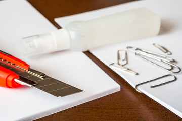 Stationery on the desk in the office, a knife on the paper 