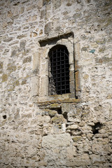 Fototapeta na wymiar window in the wall of an ancient fortress