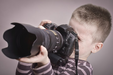 Young boy taking pictures