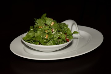 Rocket salad with cheese and pine nuts