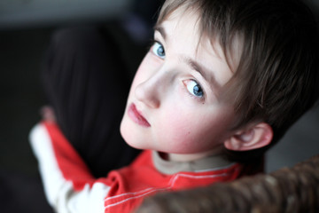 Portrait of beautiful thoughtful little boy with attentive look 