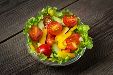Fresh salad on wooden background