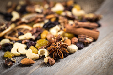 Close-up of nuts and dried fruits mix on wooden surface.