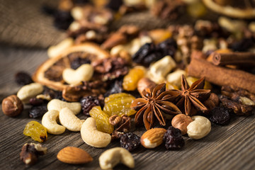 Close-up of nuts and dried fruits mix on wooden surface.