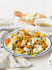 salad with pear, pumpkin, nuts and blue cheese