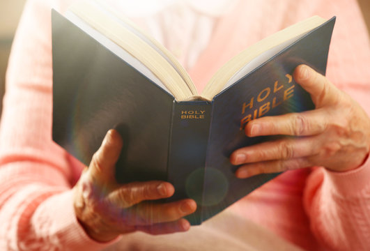 Old woman reading Bible, closeup
