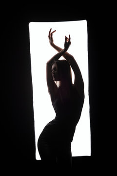 Silhouette of elegant dancer posing in frame