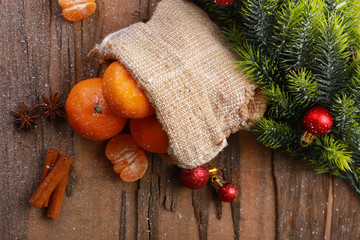 Christmas composition with tangerines on wooden background