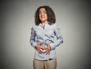 woman hands on stomach having bad aches pain grey background 