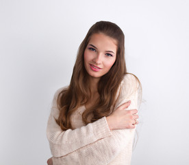 Young woman standing, isolated on gray background