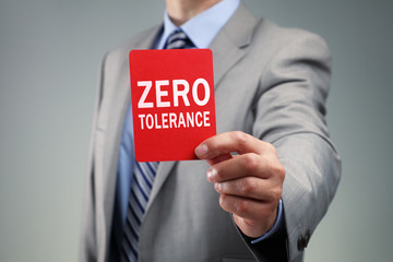 Businessman showing the zero tolerance red card