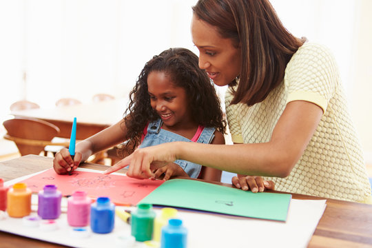 Mother Painting Picture With Daughter At Home