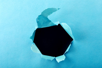 Hole in the paper with torn sides